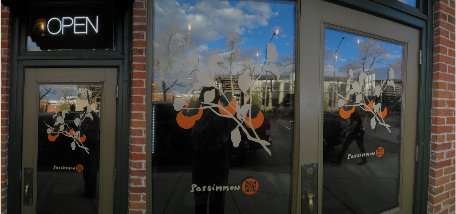 Persimmon storefront door decal: persimmon branch illustration and logotype on the glass