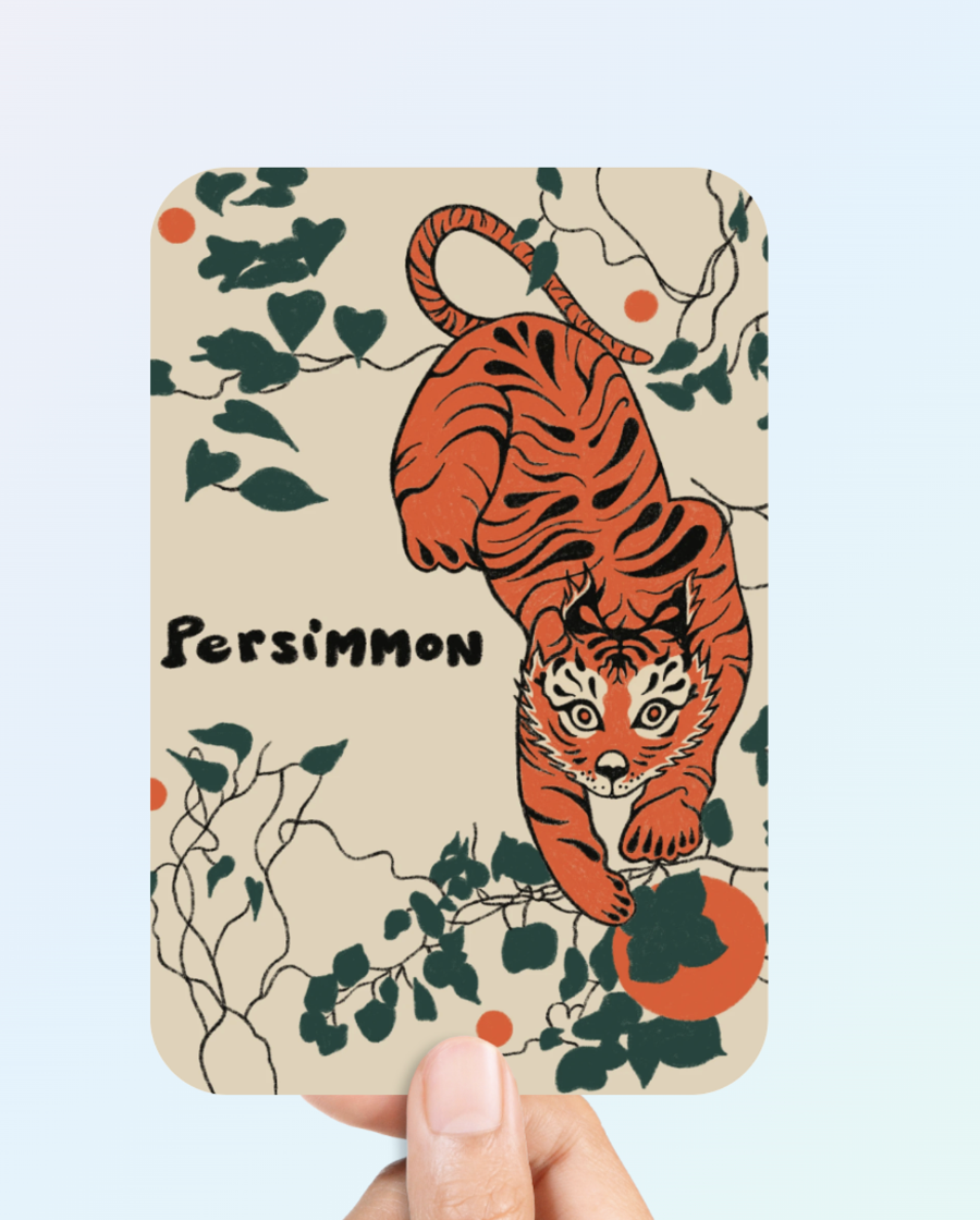Soft touch postcard with the Persimmon tiger illustration held in hand